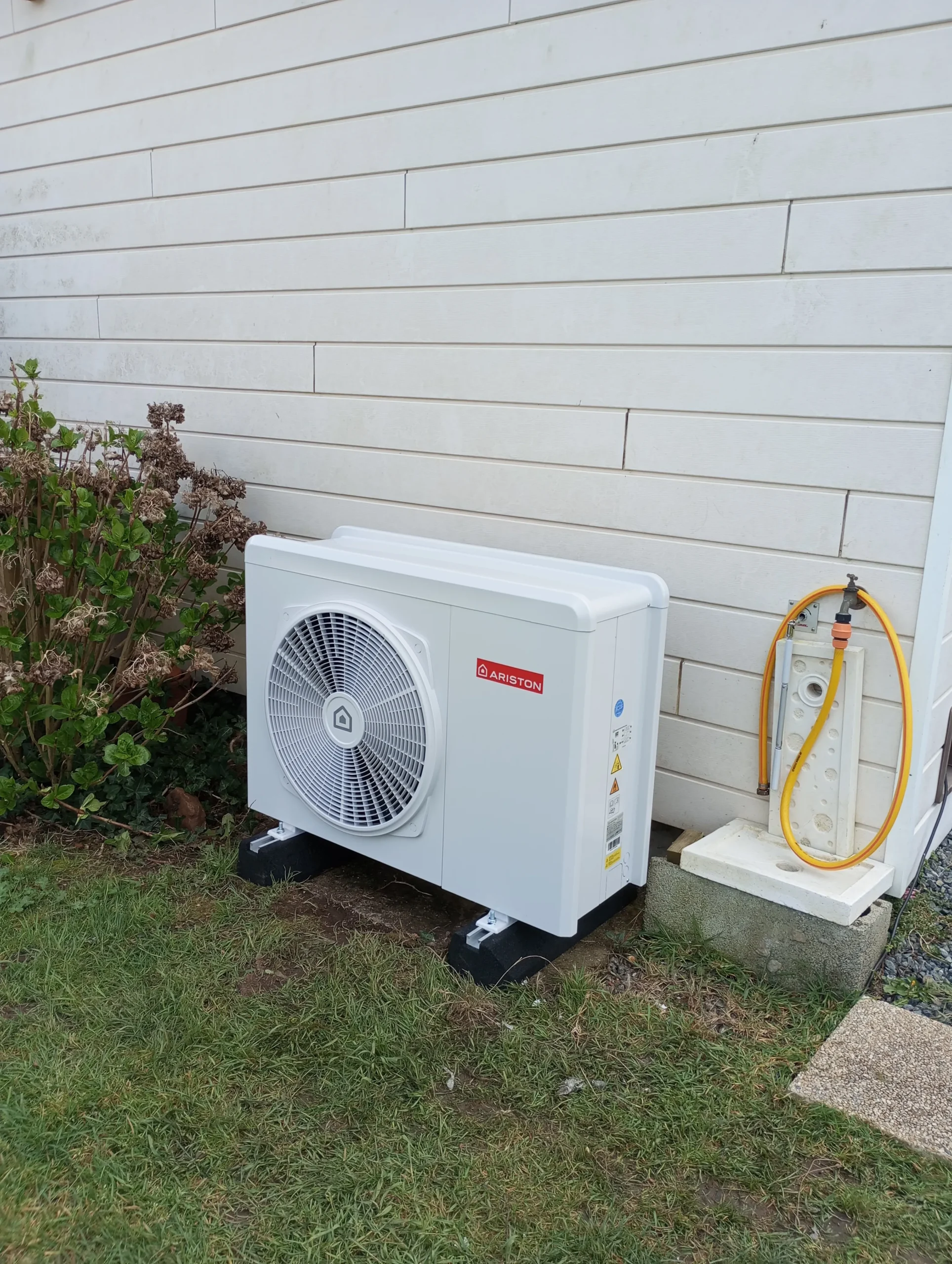 Installation d'une unité extérieure de pompe à chaleur Ariston.